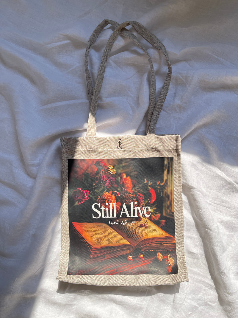 Still alive tote bag